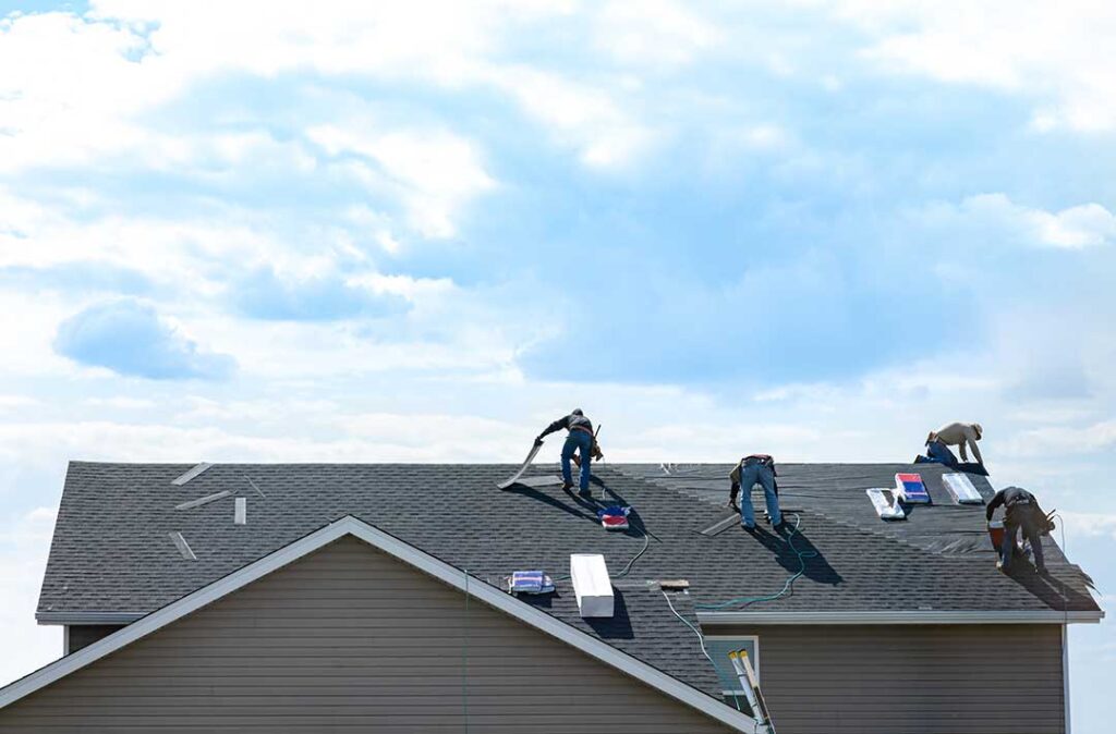 Rainwater flows from a shingled roof edge into a gutter beside a vented soffit.
